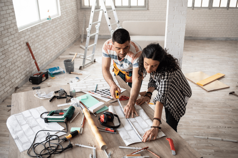 Two people working on a DIY table